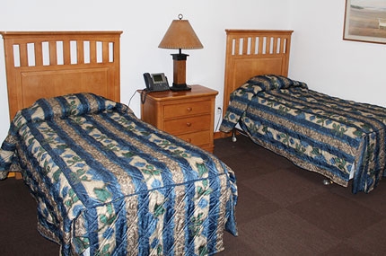 Two twin beds in a room at YMCA Sleepaway Camp.