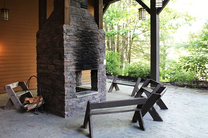 An outdoor fireplace and some benches at YMCA Sleepaway Camp.