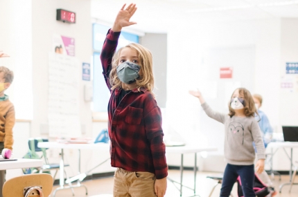 Kids in masks stretch and do exercises at the Y.