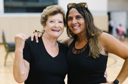 two women smiling in a gym