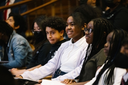 Teens sitting in auditorium