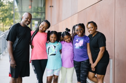 family standing in front of the Y