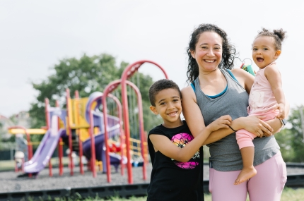 mom and two children standing outside 