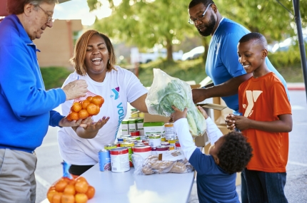 volunteer handing out fresh food