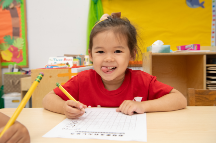 child working on a worksheet in a classroom