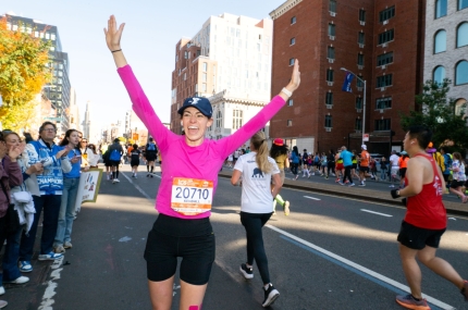 2025 Marathon runner stops to say hi to Y Cheer Zone.