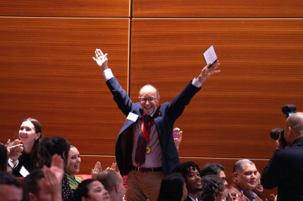 Y volunteer cheering from his seat