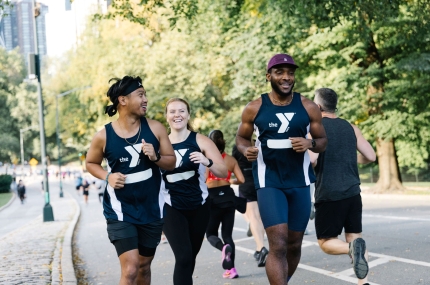 Three Team Y Champions runners run side by side in Central Park.