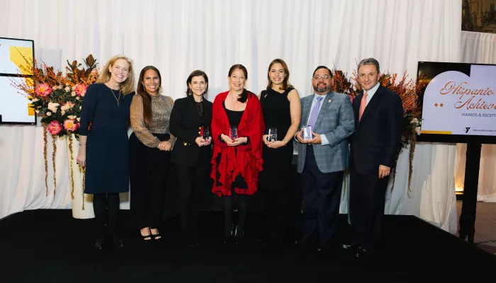 seven adults standing with awards