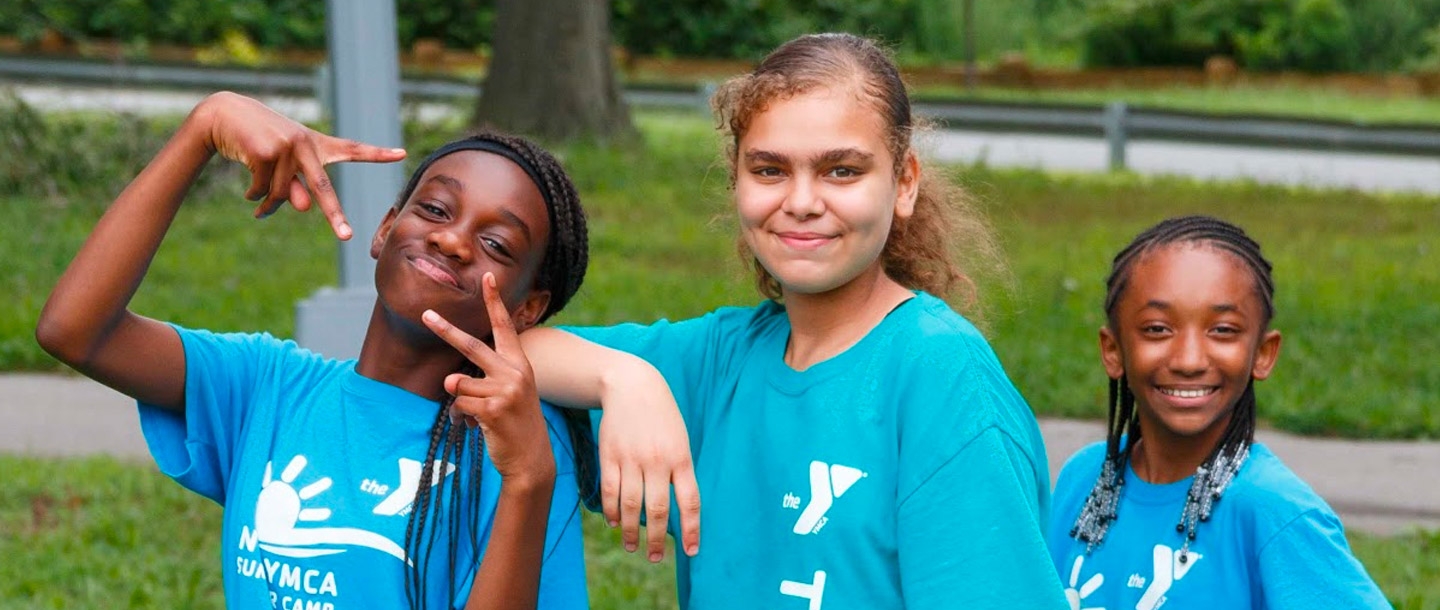 Three kids at the North Brooklyn YMCA summer day camp.