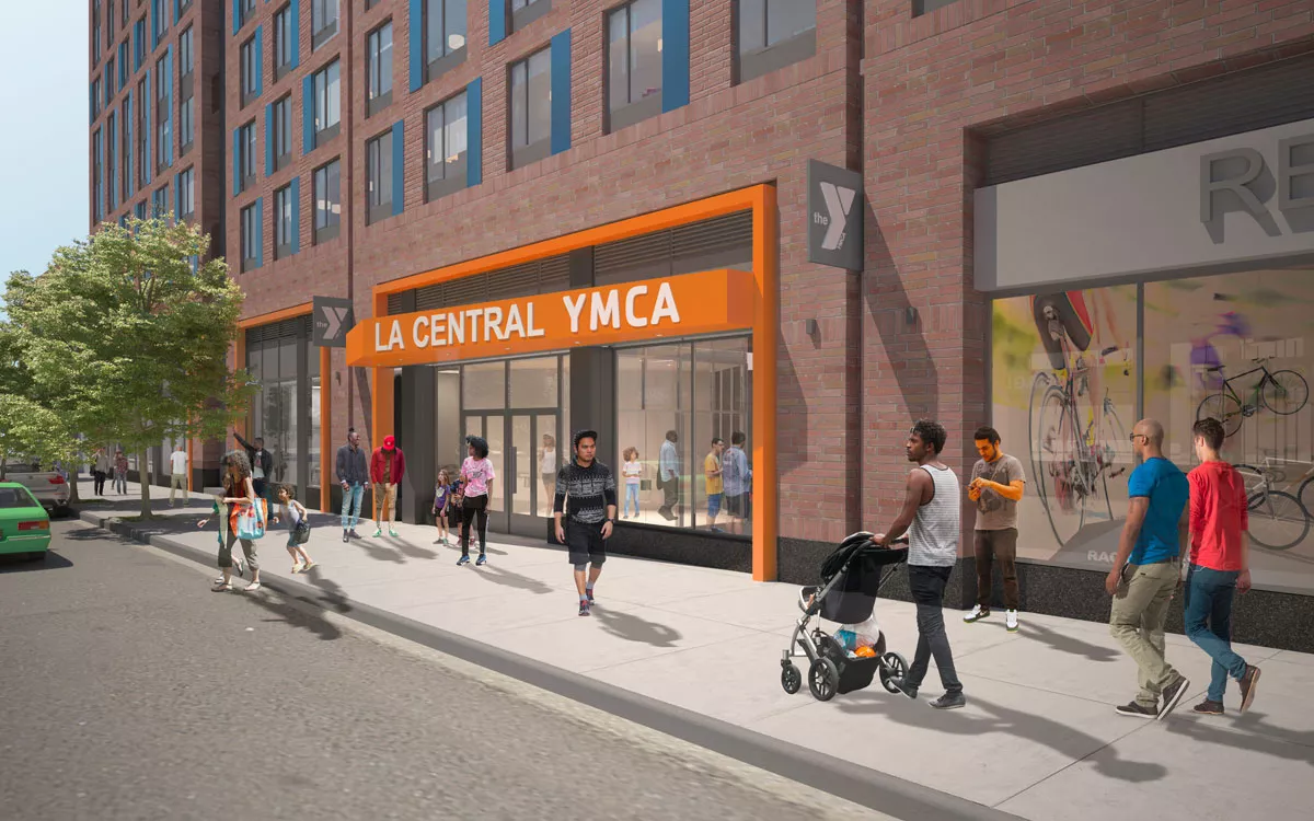 Community members walk past the exterior of La Central YMCA.