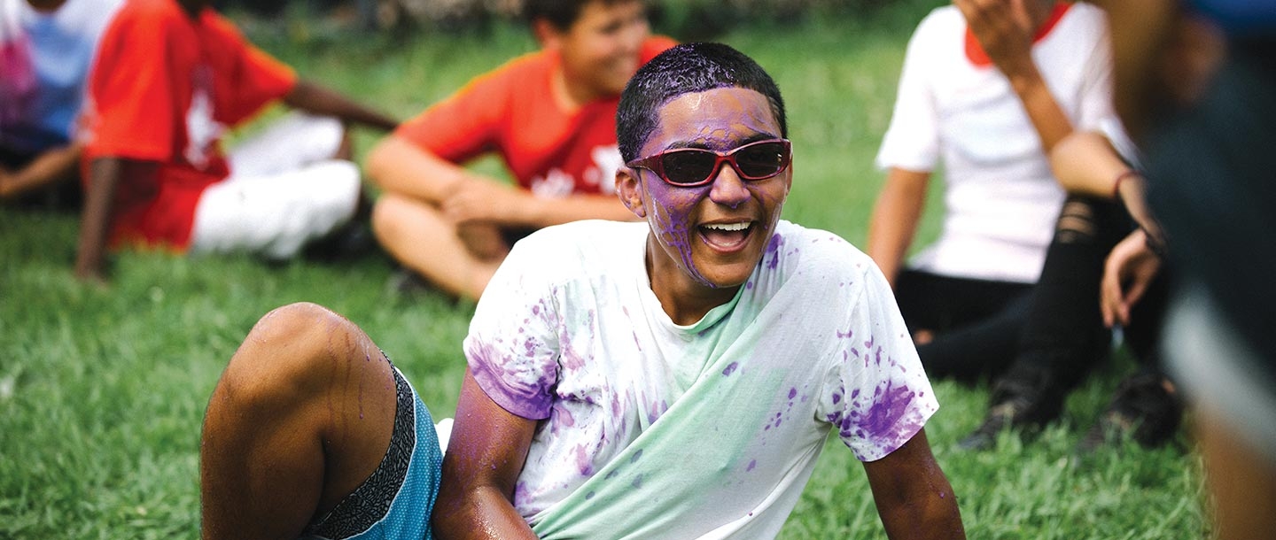 Boy covered in purple paint