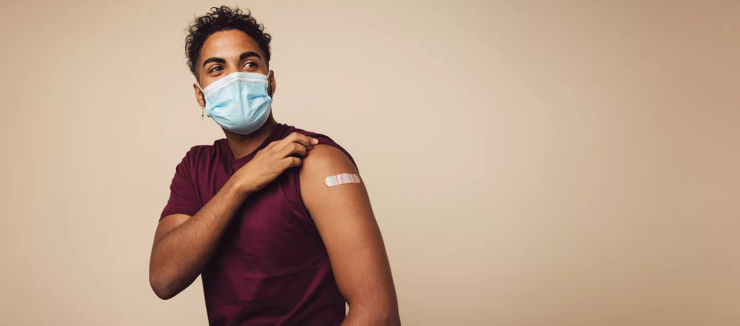 A man wearing a mask posing after getting vaccinated