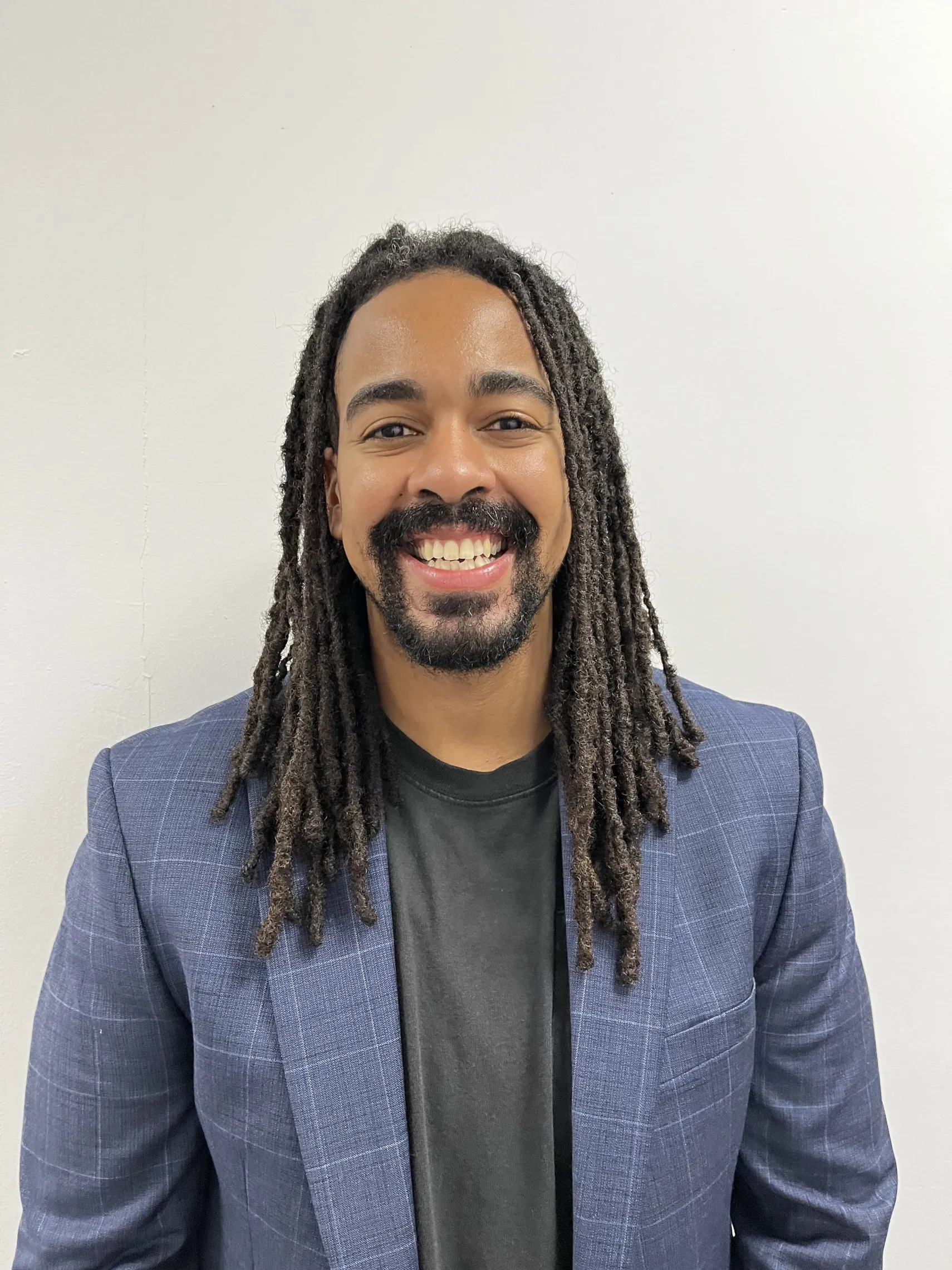 man with dreads smiling