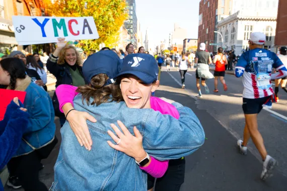 2025 Y marathon runner hugs Y Staff along route.