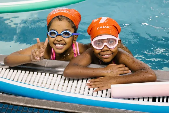 Two kids in a pool at Cross Island Y.