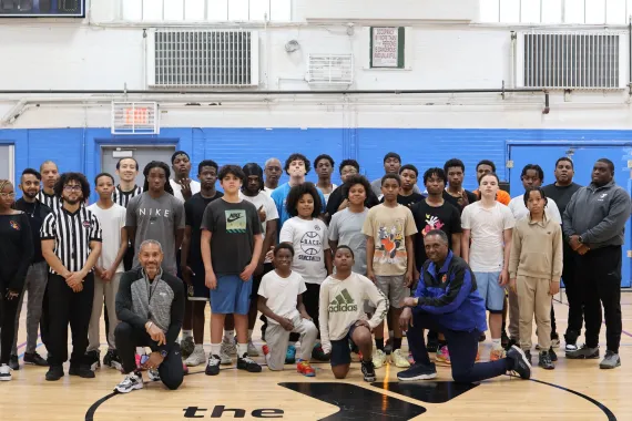 Teens at Jamaica Y pose in basketball court for Hydroquebec event.