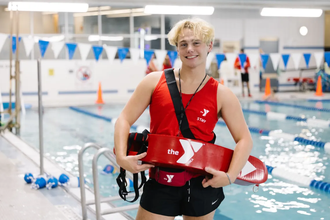lifeguard smiling in front of pool
