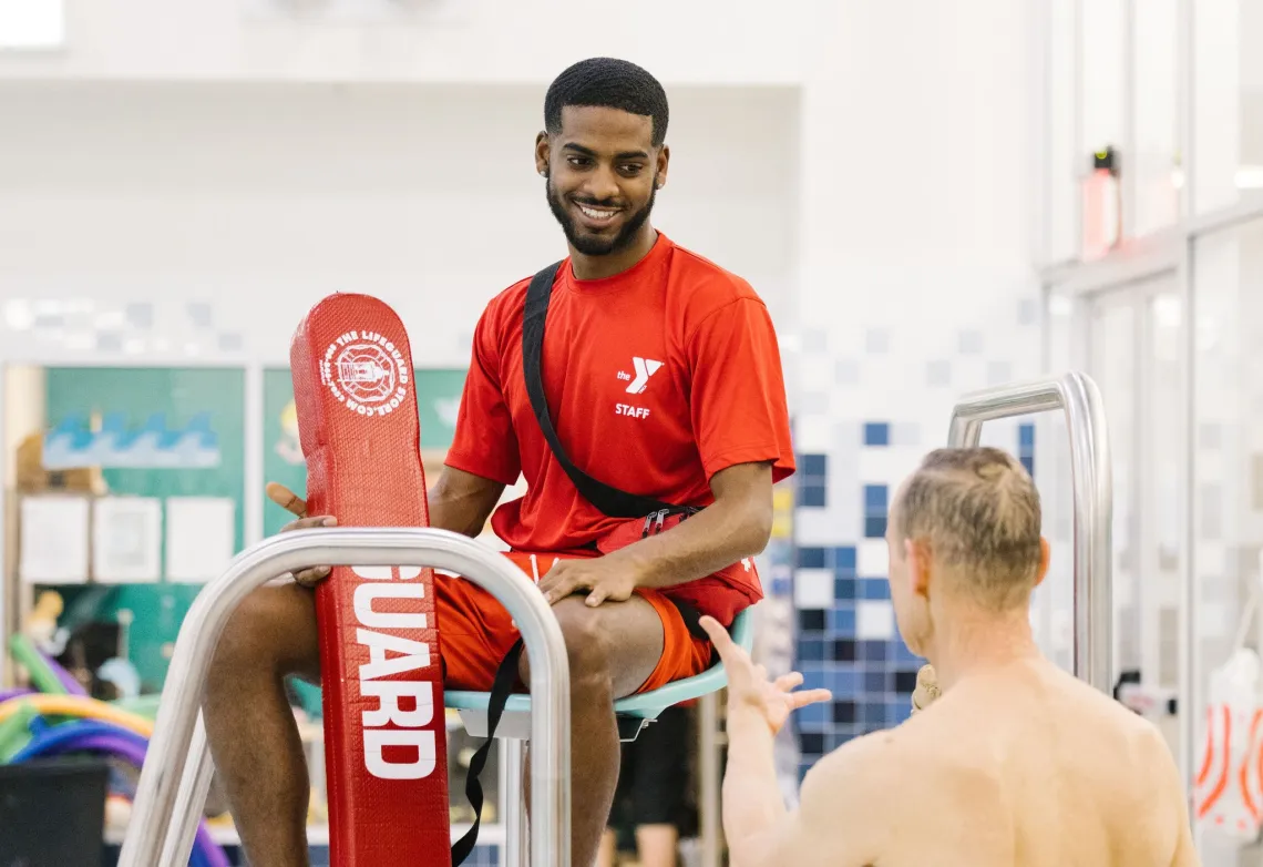 lifeguard talks to a swimmer