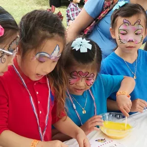 Kids with face painting at Cross Island Touch a Truck event
