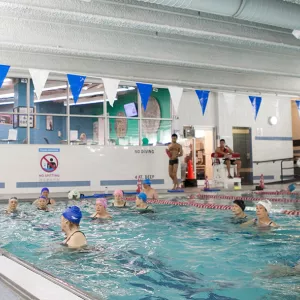 Adults taking water exercise class in the pool at the YMCA in Manhattan 