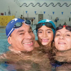 Family swimming at YMCA pool in Brooklyn