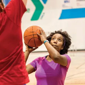 Adults playing basketball at the YMCA