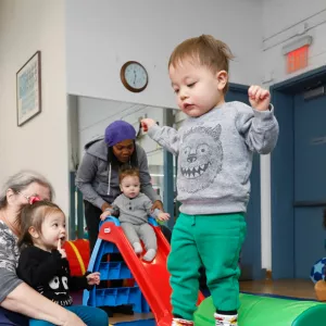 Kids and their parents and caregivers play at the Bed-Stuy YMCA.