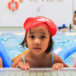 Three girls swimming in LIC YMCA pool