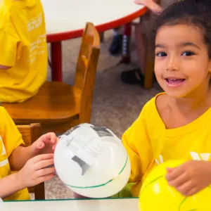 Two preschool girls make art project in Greenpoint YMCA summer camp in Brooklyn