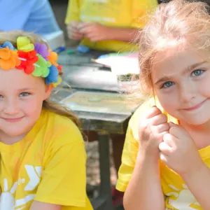 Two girls with flower crowns outside during Staten Island YMCA summer camp