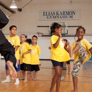 Bronx summer camp kids doing martial arts in YMCA gymnasium
