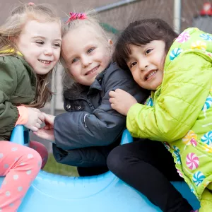 Preschool girls playing outside at YMCA UPK program playground