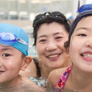 Son, mother, and daughter swimming at Rockaway YMCA indoor pool