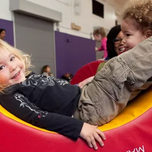 Toddlers playing at indoor gym in Brooklyn YMCA class