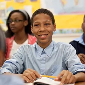 High school boy smiling in classroom