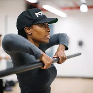 Woman lifting weight in strength training class for women at Bedstuy YMCA in Brooklyn