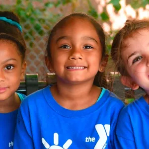 Three girls in kinder camp at the Dodge YMCA summer camp.