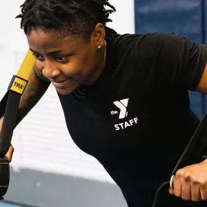 YMCA instructor demonstrates TRX