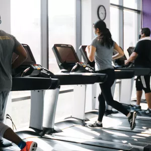 YMCA members in masks run on spaced out treadmills.