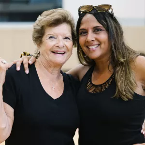 two women smiling in a gym