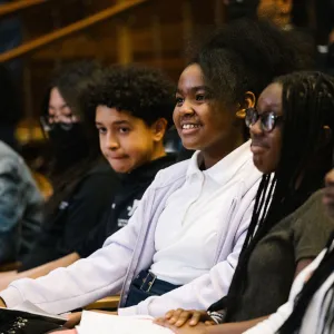 Teens sitting in auditorium