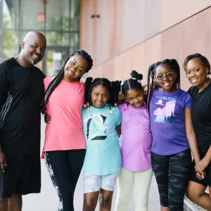 family standing in front of the Y