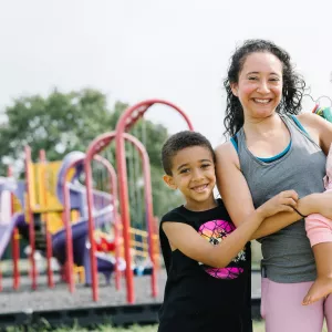 mom and two children standing outside 