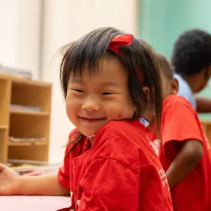 girl smiling and coloring