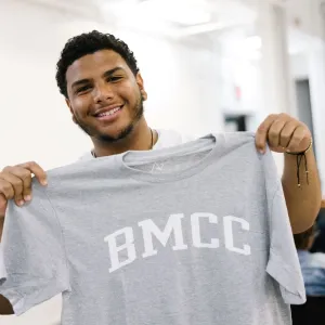guy holding college t-shirt