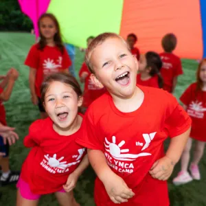 2 kids under a parachute