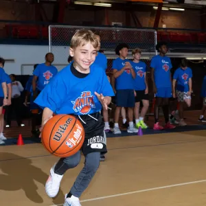 kid dribbling basketball