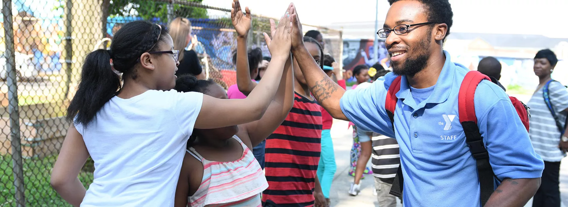 Afterschool staff working with school kids at YMCA program