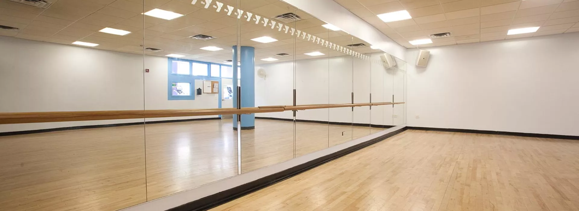 Studio for group exercise classes with mirrors and barre at Dodge YMCA in Brooklyn